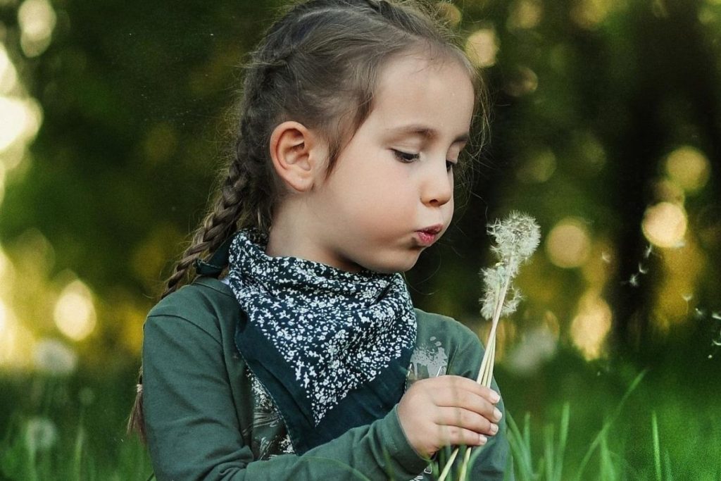 Girl Blowing Dandelion